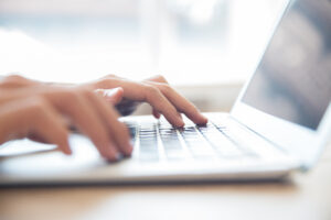 close up male hands typing laptop keyboard